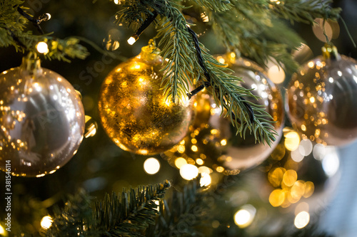 Closeup of Christmas tree gold ball decorations.