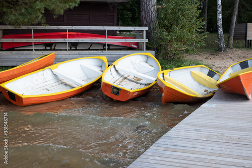 Colorful boats and a canoe on shore.