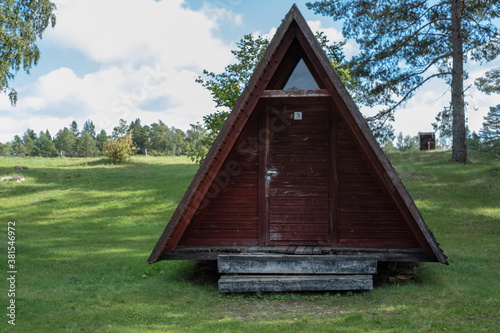 A-frame house or building, triangle shape house. Wooden tent summer house or camping, vacation home. Popular architectural style post–World War II. Wide spread in Estonia during Soviet-era. photo