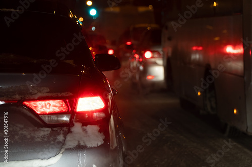 Cars in a winter night traffic jam in the city at night. Selective focus