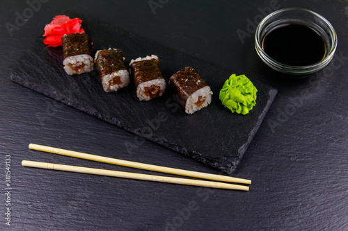 Sushi maki rolls with tuna on black slate