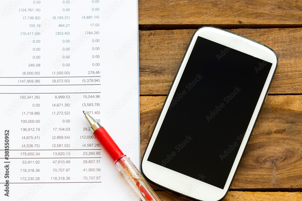 financial statement for check with mobile phone for business work of personal arrangement flat lay style at office desk financial statement for check with mobile phone for business work of personal arrangement flat lay style at office desk