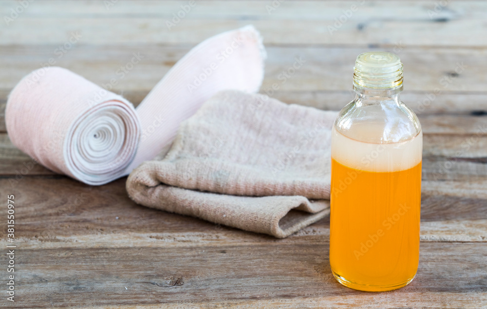 first aid with herbal oil medication liniment and bandage health care pains and aches for athlete decoration on background wooden first aid with herbal oil medication liniment and bandage health care pains and aches for athlete decoration on background wooden