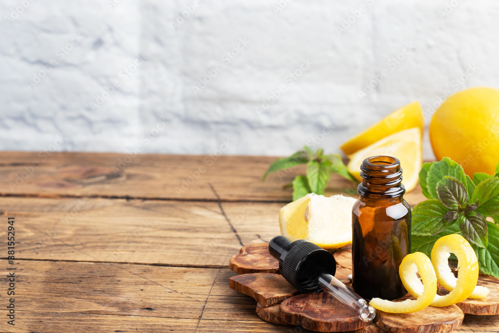 Lemon citrus fruit essential oil and mint, aromatherapy oil natural organic cosmetic on rustic wood background.