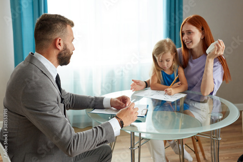 Принти на полотні young depressed caucasian woman with child girl get support by psychologist, the