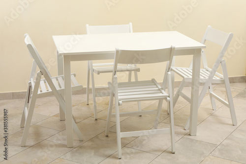 White table and folding chairs in kitchen room