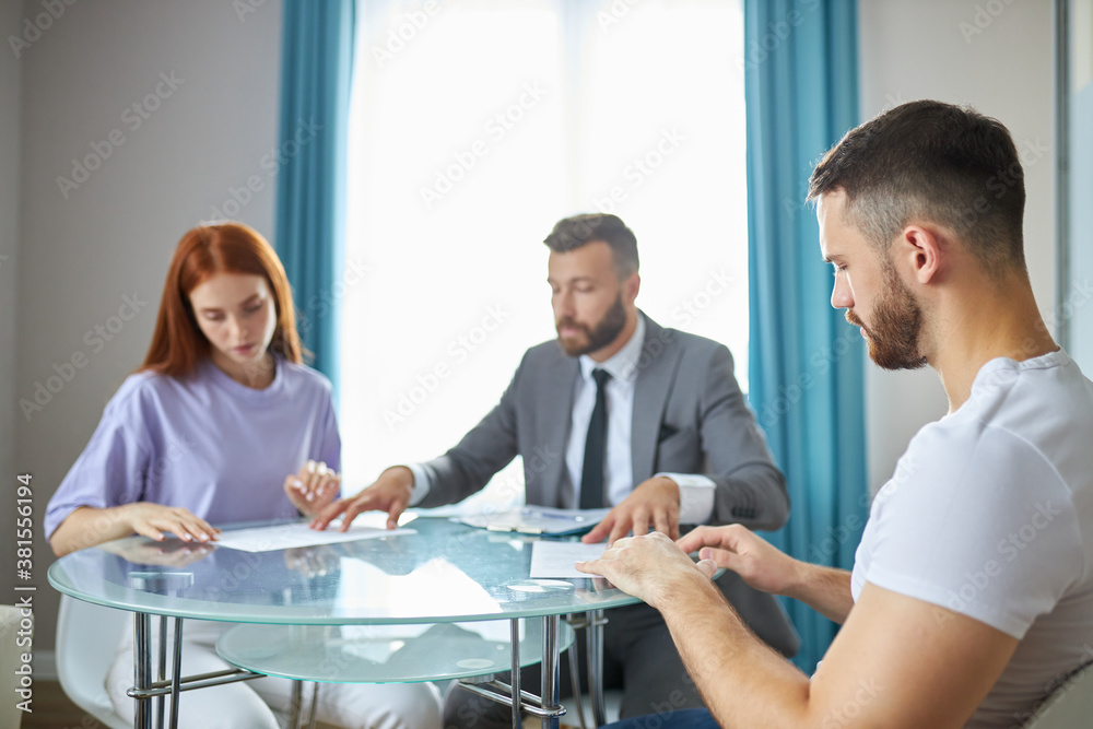 caucasian family couple turned to a lawyer to sign a divorce agreement, man and woman always quarrel and argue with each other. confident male lawyer prepares the documents