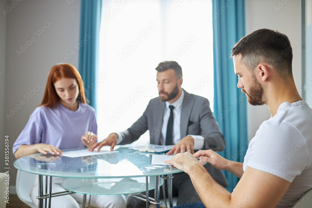 caucasian family couple turned to a lawyer to sign a divorce agreement, man and woman always quarrel and argue with each other. confident male lawyer prepares the documents caucasian family couple turned to a lawyer to sign a divorce agreement, man and woman always quarrel and argue with each other. confident male lawyer prepares the documents