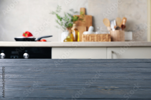 Wood table on blur kitchen room background