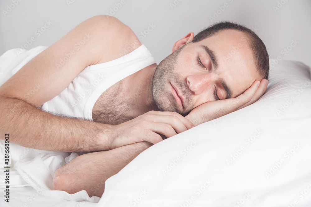 Caucasian man sleeping in bed. Caucasian man sleeping in bed.