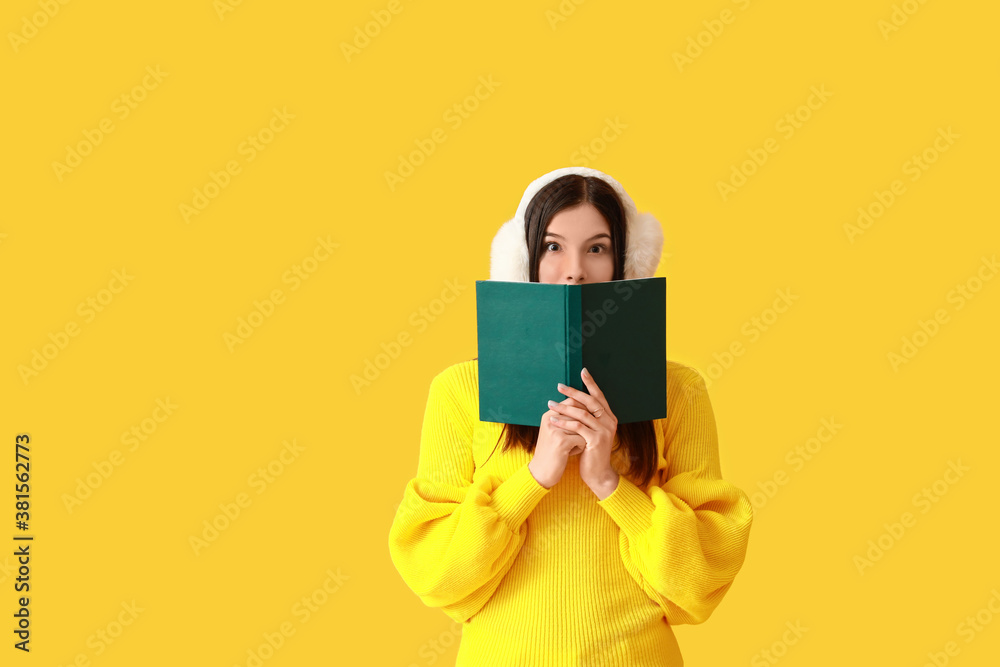 Beautiful young woman with book on color background Beautiful young woman with book on color background