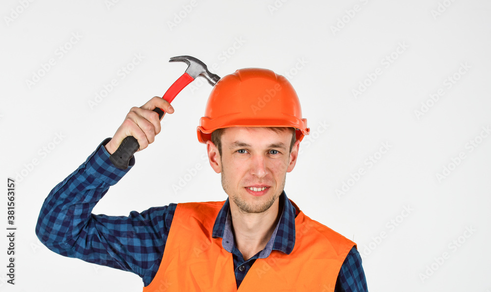 man builder use hammer. professional repairman in helmet. build and construction. skilled architect repair and fix. engineer worker career. tools for repair. young man in hard hat