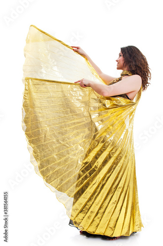 Beautiful young female dancer in traditional  dress in with golden Isis wings in various poses photo