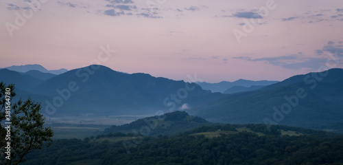 Early morning one hour before dawn. Silhouettes of mountains in the morning haze. Lagonaki Plateau  Republic of Adygea  Russia