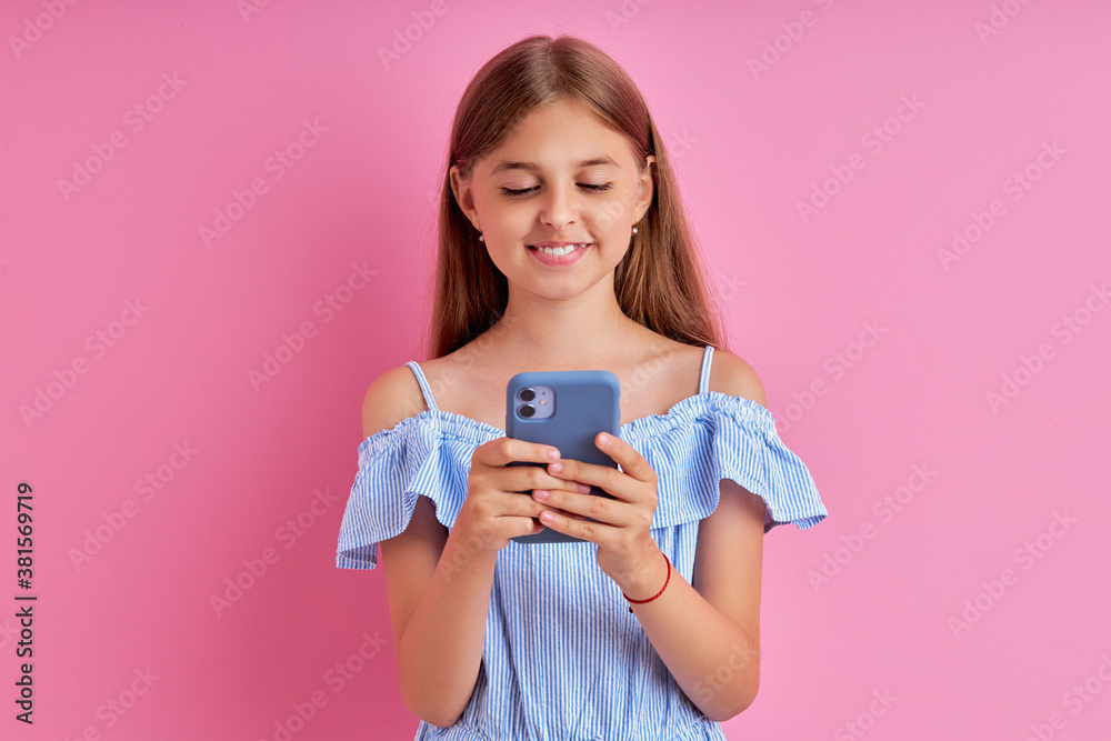 adorable caucasian teen girl use smartphone, chatting with friend, pretty long haired girl look ar screen of mobile phone, isolated pink background adorable caucasian teen girl use smartphone, chatting with friend, pretty long haired girl look ar screen of mobile phone, isolated pink background