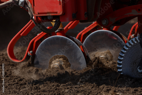 Sowing machine close up. Seeding crop with dry fertilizer. Disc coulters. photo