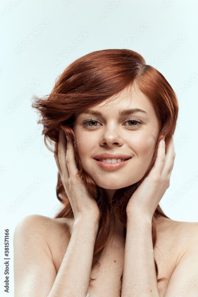 Pretty woman holding hair smile cosmetics lifestyle naked shoulders hairstyle care charm light background Pretty woman holding hair smile cosmetics lifestyle naked shoulders hairstyle care charm light background