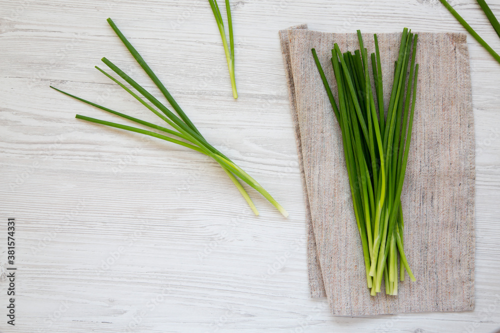 Raw Green Onions on a white wooden background, top view. Flat lay, overhead, from above. Copy space. Raw Green Onions on a white wooden background, top view. Flat lay, overhead, from above. Copy space.