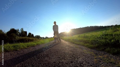 Wallpaper Mural Slow motion shot of mother helping a toddler with her first steps during scenic sunset in rural landscape Torontodigital.ca