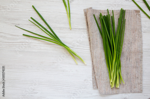 Raw Green Onions on a white wooden background  top view. Flat lay  overhead  from above. Copy space.
