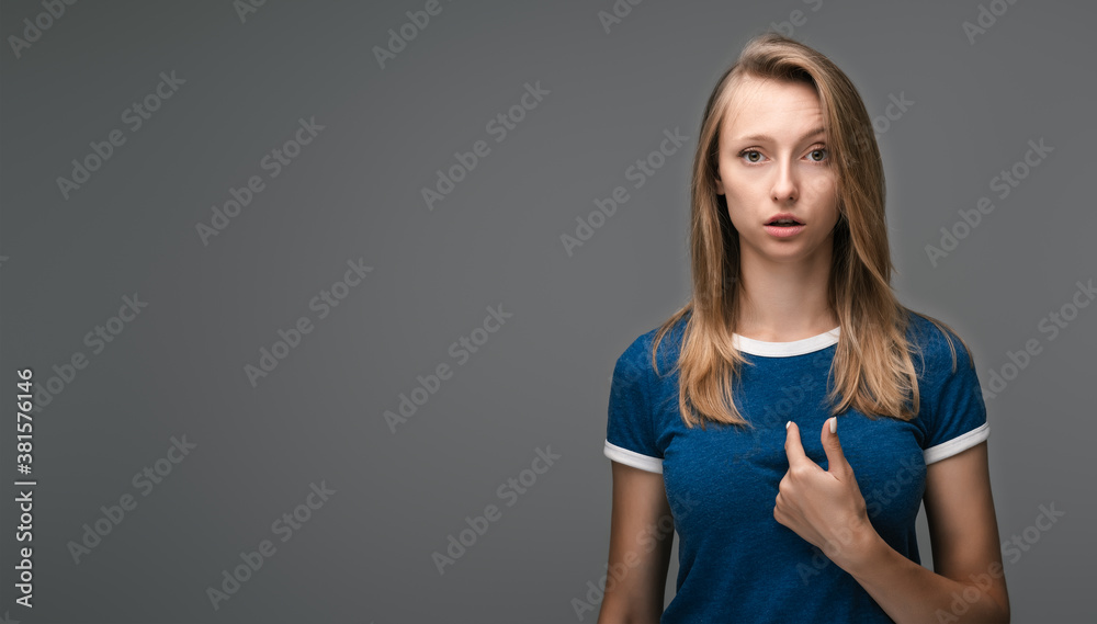 Indignant woman points at herself with fore finger opens mouth in surprisement, has questioning expression. Copy space Indignant woman points at herself with fore finger opens mouth in surprisement, has questioning expression. Copy space