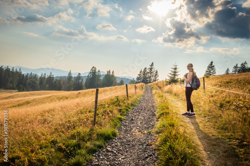 Fifteen year old girl standing on a path in the Black Forest of Germany on a summer day. 