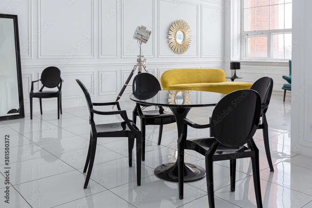 modern fashionable futuristic interior design of a spacious white hall with black and yellow furniture