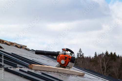 blower on waterproofing tarpaper layer on folded roof under construction