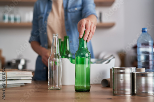 Woman segregating garbage for recycling photo