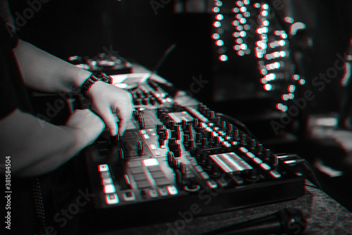 male DJ mixes electronic music on a professional music controller