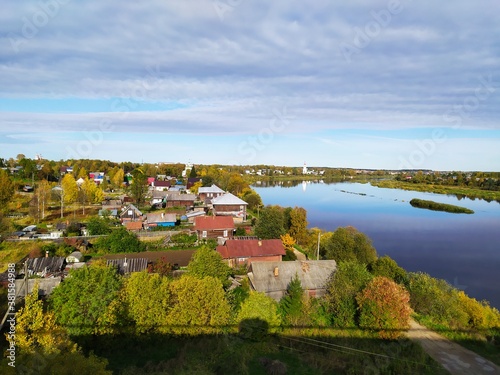 Rural landscape with wide calm river in aurumn