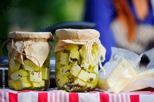 Photography pieces of cheese in brine in a glass jar close-up