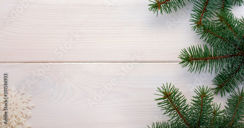 Christmas fir tree with snowflake on a white wooden board and copy space for your text. Banner.Flat lay