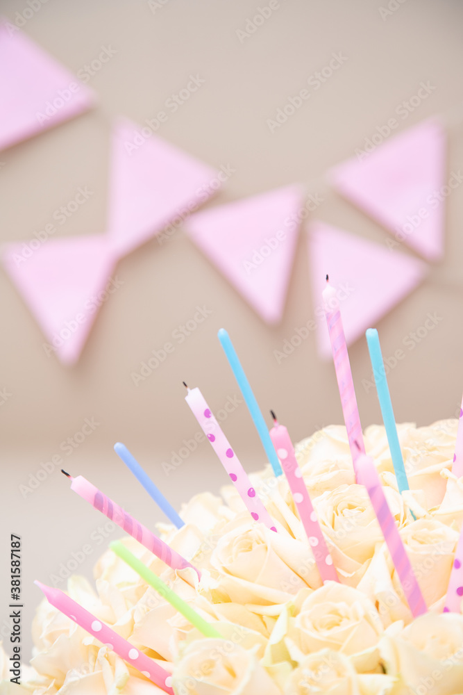 Cream pastel rose with holiday candles on a celebrating craft background