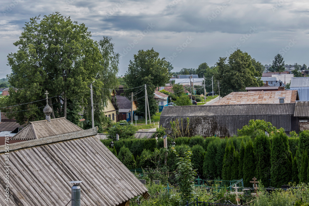 City street in the middle of summer. Roofs, trees, chimneys. View from the bell tower of the church. Provincial town of Borovsk in Russia.