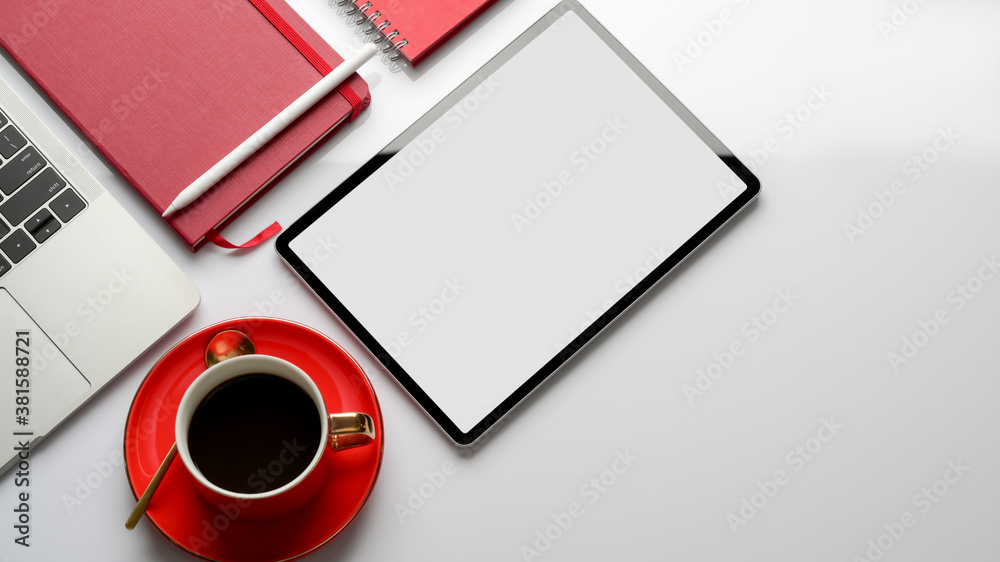 Female office worker looking into camera while working on office desk