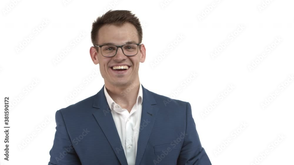 Handsome successful male entrepreneur with blond hair, wearing blue suit with glasses, shouting for joy and victory, fist pump and saying yes, smiling while triumphing over white background Handsome successful male entrepreneur with blond hair, wearing blue suit with glasses, shouting for joy and victory, fist pump and saying yes, smiling while triumphing over white background