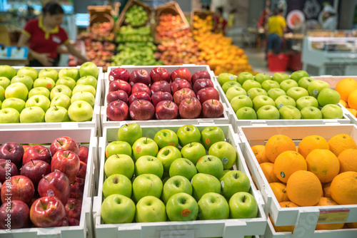 Fresh healthy fruits on shelves in supermarket