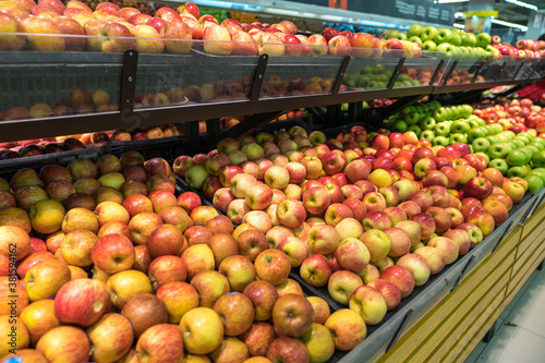 Fresh healthy fruits on shelves in supermarket