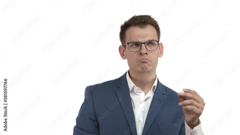 Handsome young businessman in blue suit and glasses vibing to awesome music, dancing and snapping fingers to the rhythm, standing over white background Handsome young businessman in blue suit and glasses vibing to awesome music, dancing and snapping fingers to the rhythm, standing over white background