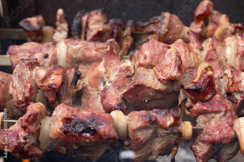 Background of pieces of meat, barbecue fried on a fire.