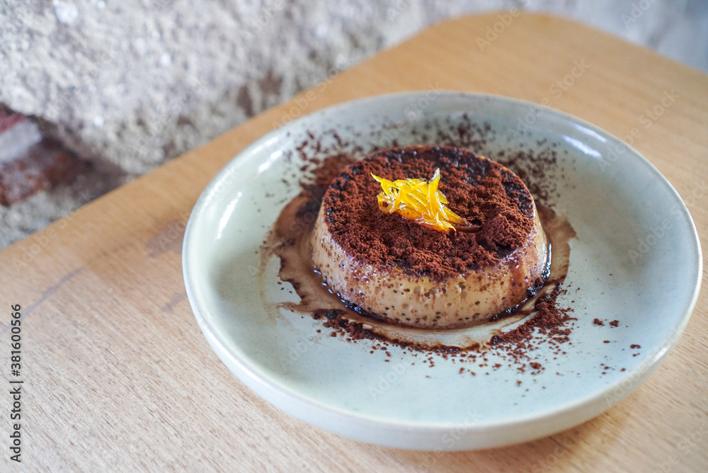 Espresso panna cotta. A caramel milk pudding topped with cocoa and espresso shot at cafe. (isolated) Espresso panna cotta. A caramel milk pudding topped with cocoa and espresso shot at cafe. (isolated)