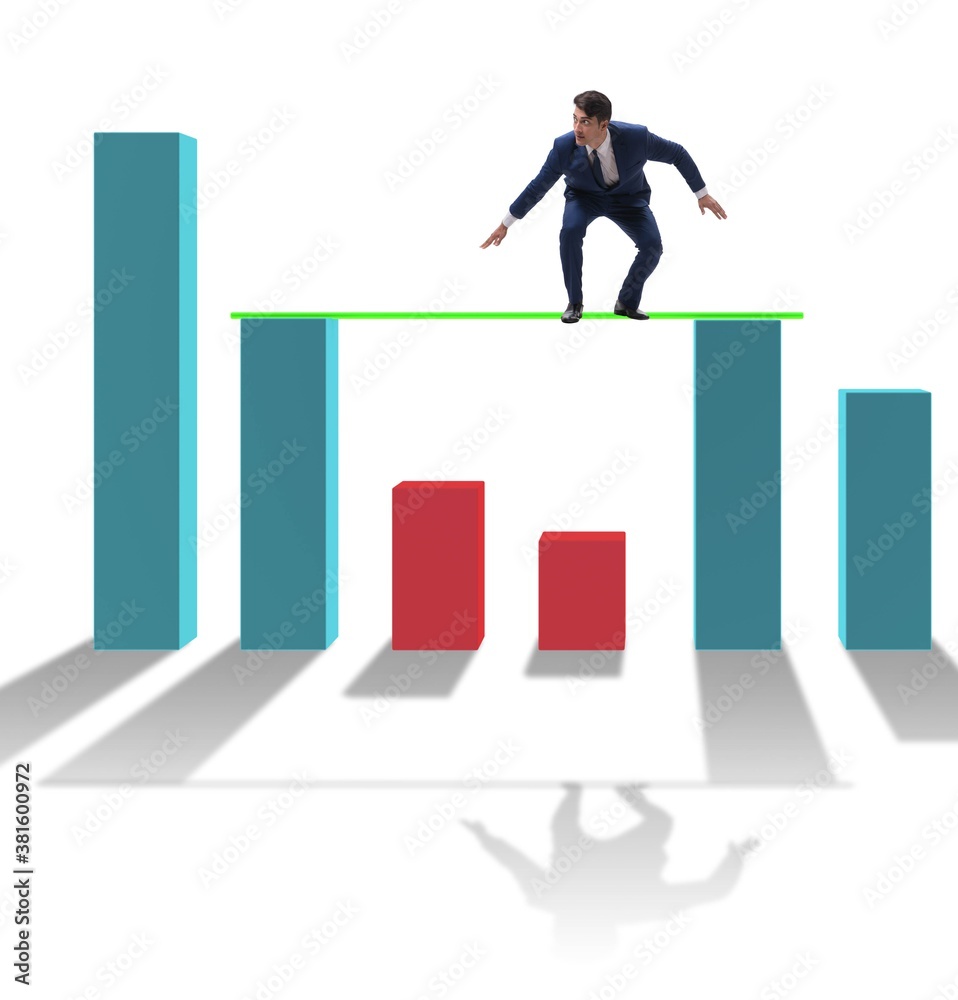 Young businessman in business concept with bar charts Young businessman in business concept with bar charts