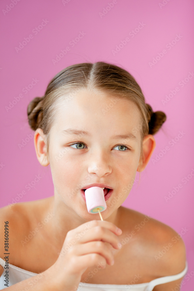 portrait of a gentle 9-year-old girl in a light T-shirt against a lilac wall portrait of a gentle 9-year-old girl in a light T-shirt against a lilac wall