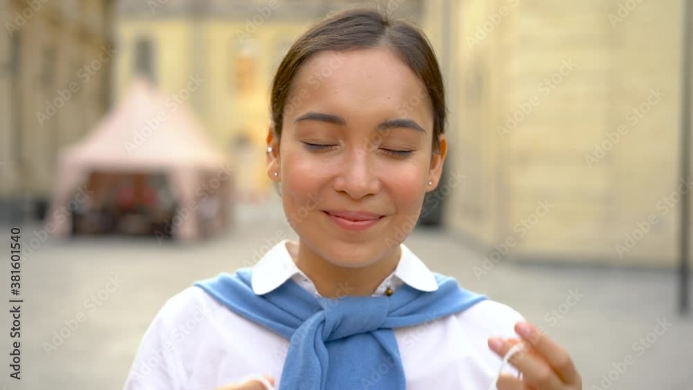 Portrait of cheerful asian woman taking off her medical mask and taking a deep breath outdoors after coronavirus lockdown. COVID-19 pandemic. Portrait of cheerful asian woman taking off her medical mask and taking a deep breath outdoors after coronavirus lockdown. COVID-19 pandemic.