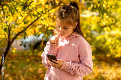  little girl talking on the phone, writing sms