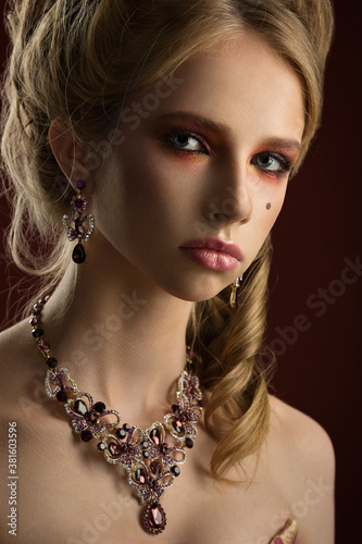 close-up portrait of beautiful sexy blonde girl with delicate facial features with stylish bright makeup and exquisite jewelry