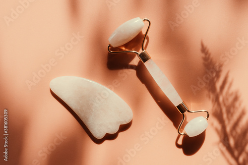 Facial jade massage roller or gua sha with trendy shadows