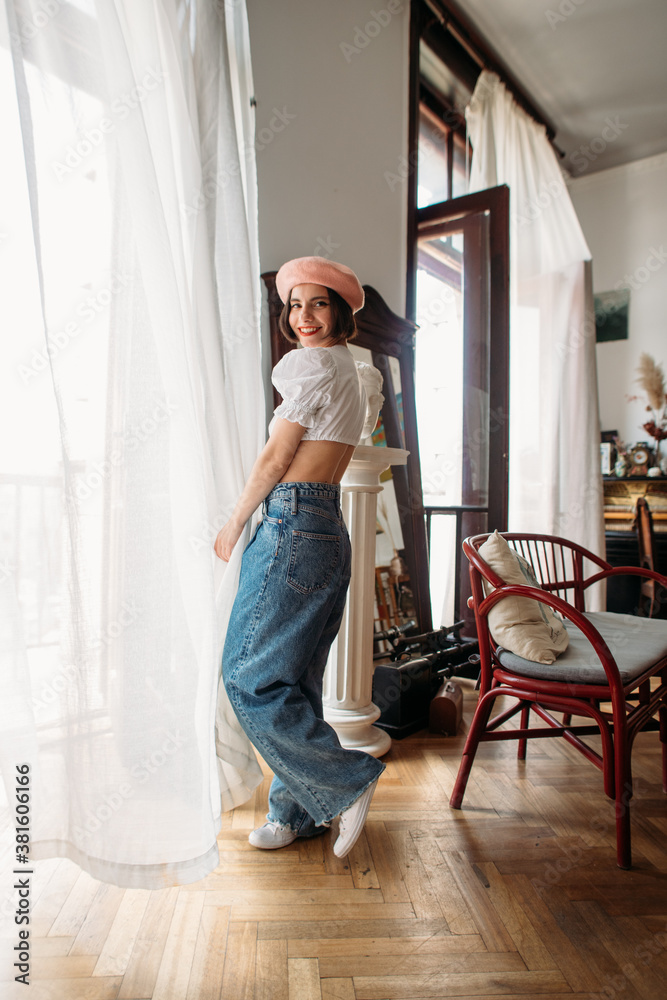 young stylish woman in a beret in an atmospheric interior