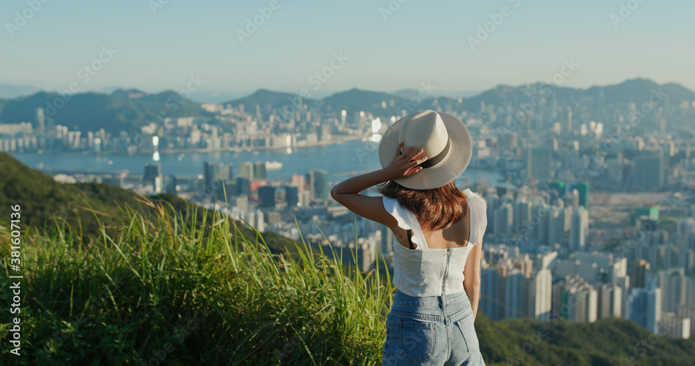 Fototapeta premium Woman look at the city view on mountain